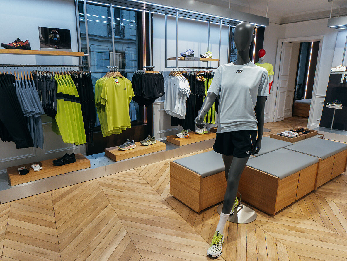 Das ansprechende Store-Design von New Balance im HERZOG MAX lädt zum Stöbern und Verweilen ein, während die Kunden ihre passenden Sportartikel entdecken.